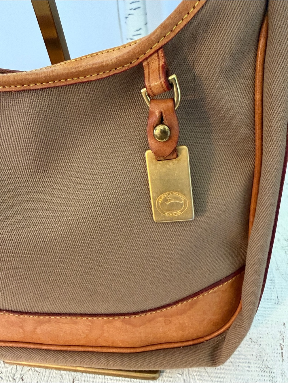Dooney & Bourke GUC tan canvas and brown leather trim shoulder /Crossbody bag